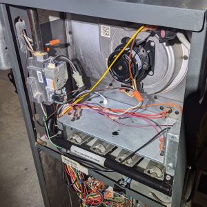 Furnace open with wires/inside mechanics showing