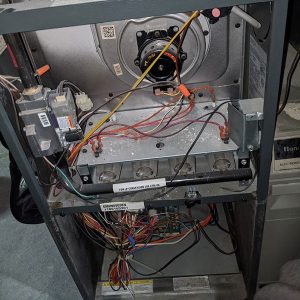 furnace open with wires and inside mechanics showing