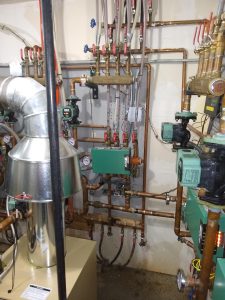 Boiler pipes on walls with gauges and valves