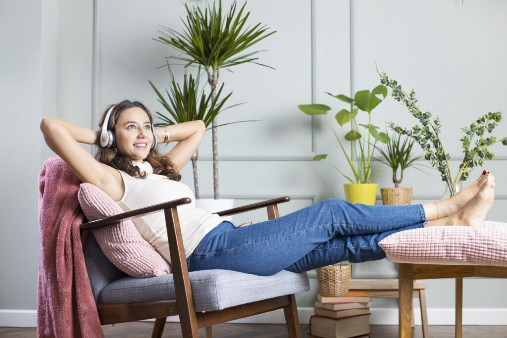 woman listening to music enjoying the temperature in her home